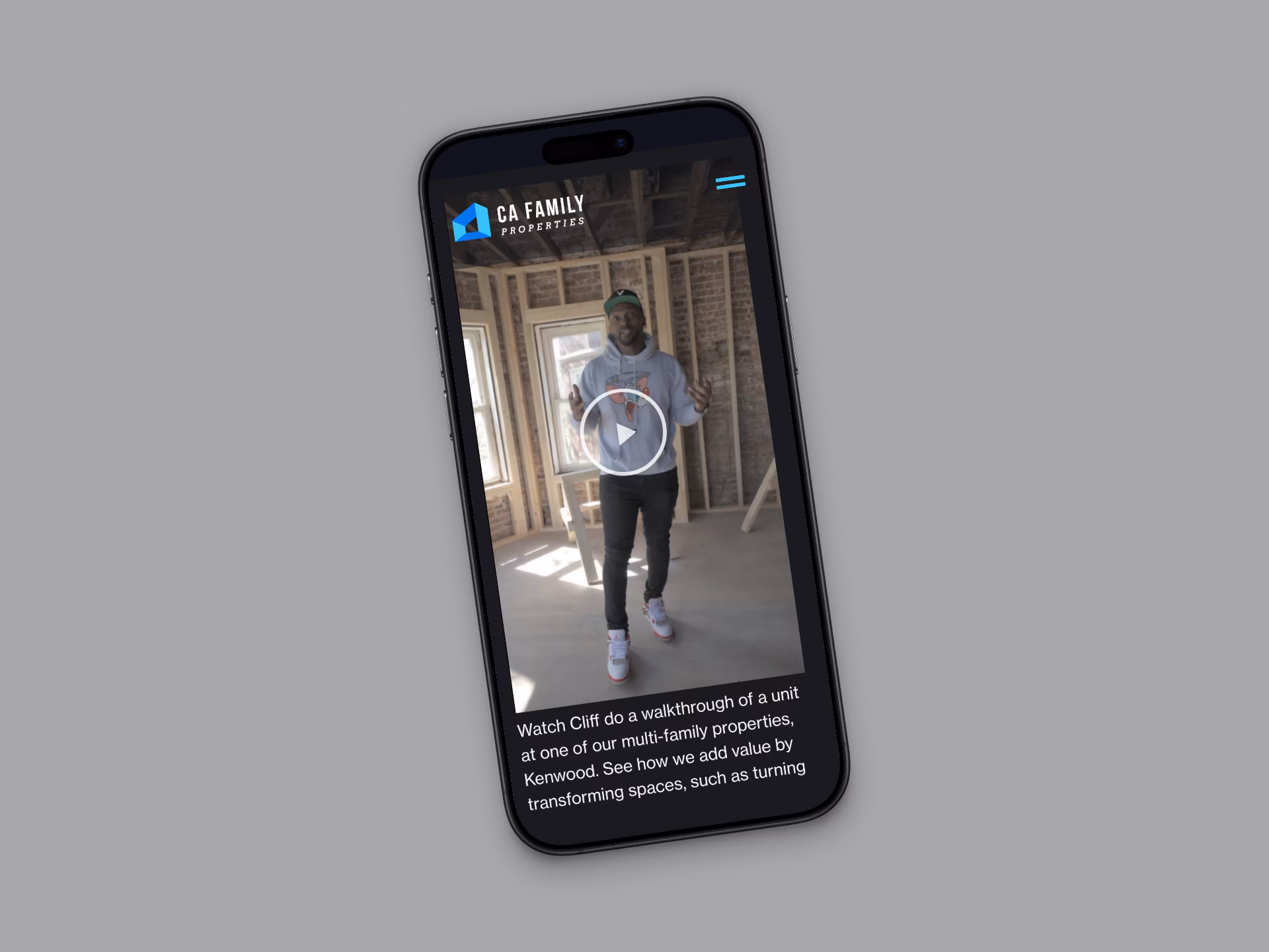 A phone playing a video walkthrough of a home under renovation