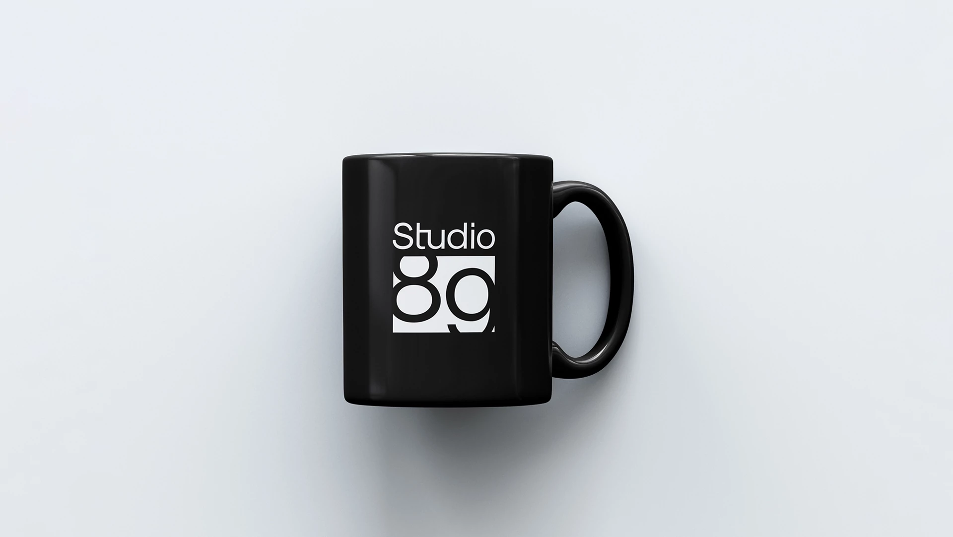 Studio89 Brand Identity on a coffee cup mockup